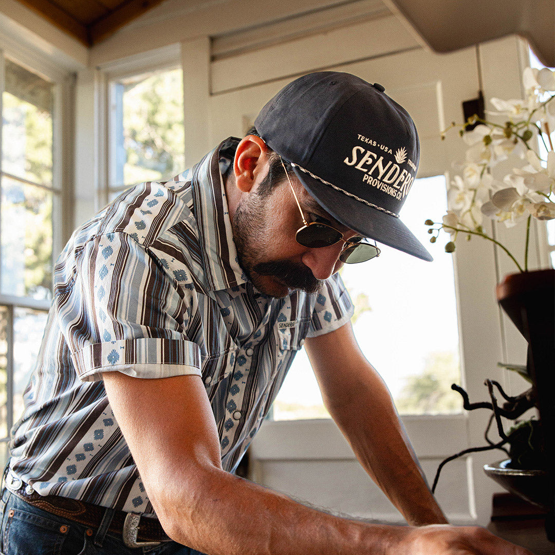 Serape Pearl Snap Short Sleeve - Sky/Brown styled on model with snapback hat and sunglasses